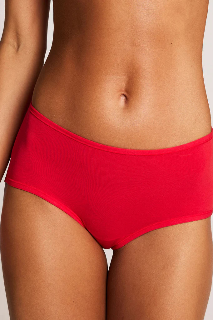 Red bikini bottom worn by a person on a plain background