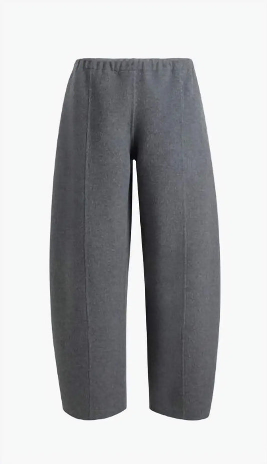 The Clover Pant in camel double-faced wool, showcasing the cropped silhouette and clean lines on a model, emphasizing its structured elegance.