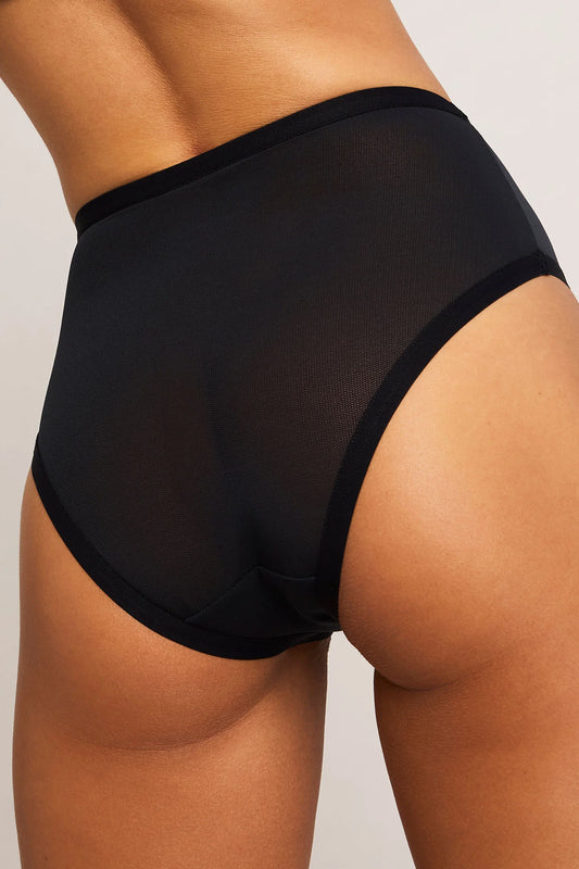 Black high-waisted underwear worn by a person on a neutral background