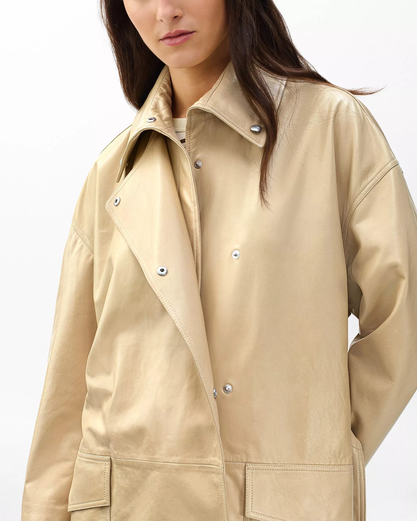 Beige jacket worn by a person on a white background