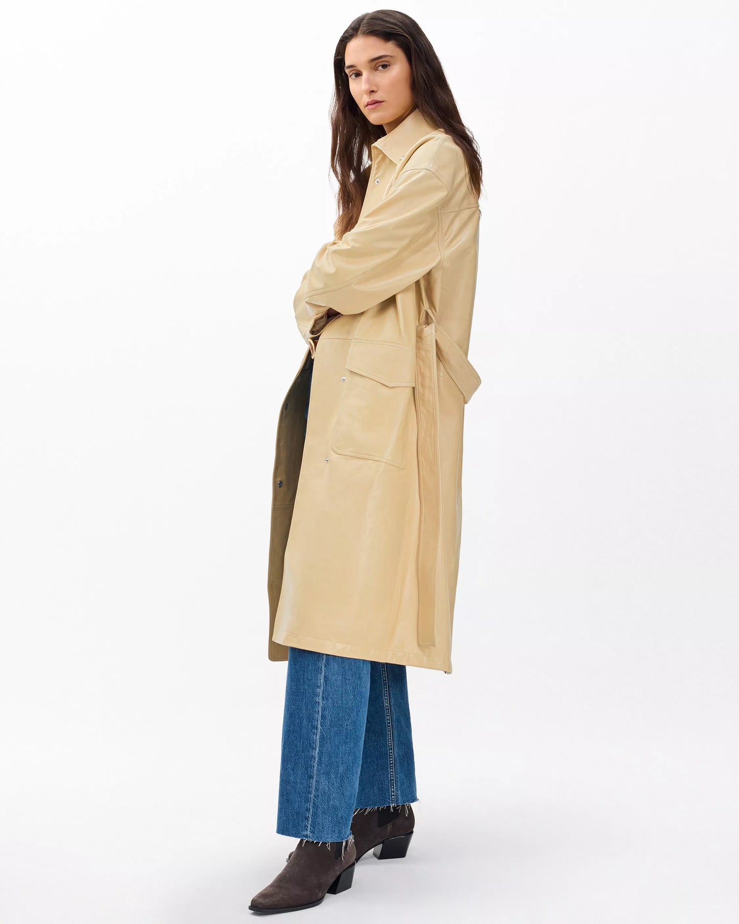 Woman wearing a beige trench coat on a white background