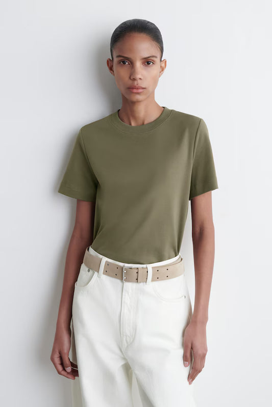 Sovereign woman in heavyweight organic cotton tee - silent authority in urban environment - Lux & Motion foundation garment
