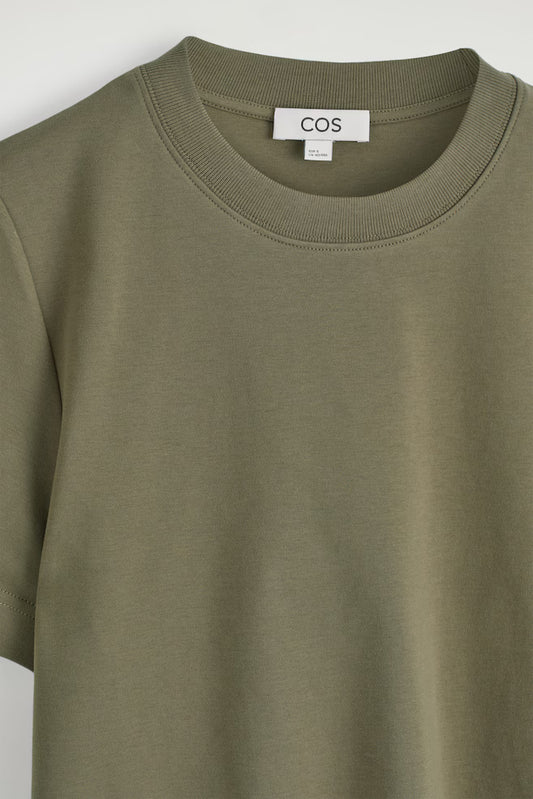 Green sweatshirt with a COS label on a white background