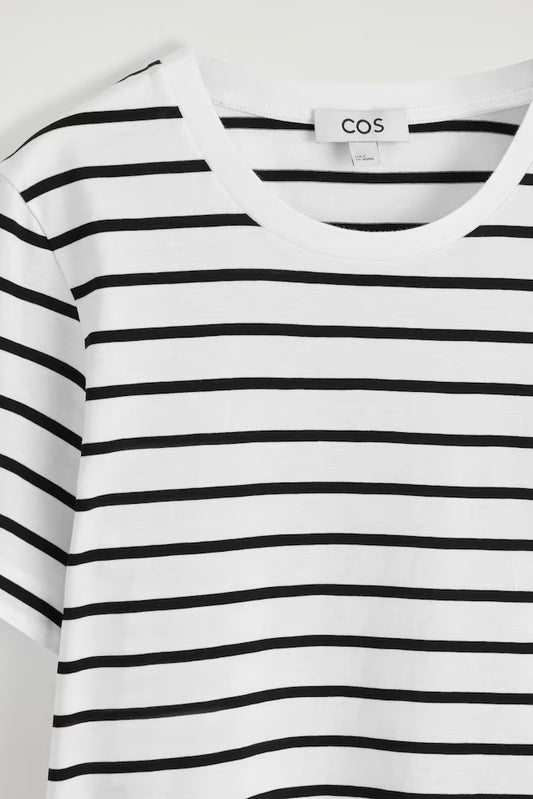 Black and white striped shirt with COS label on a white background
