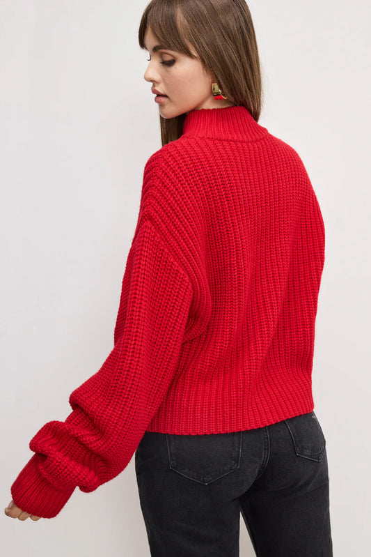 Person wearing a red knitted sweater on a white background