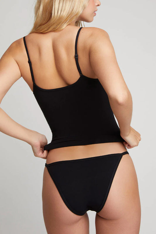 Person wearing a black tank top and underwear set on a plain background