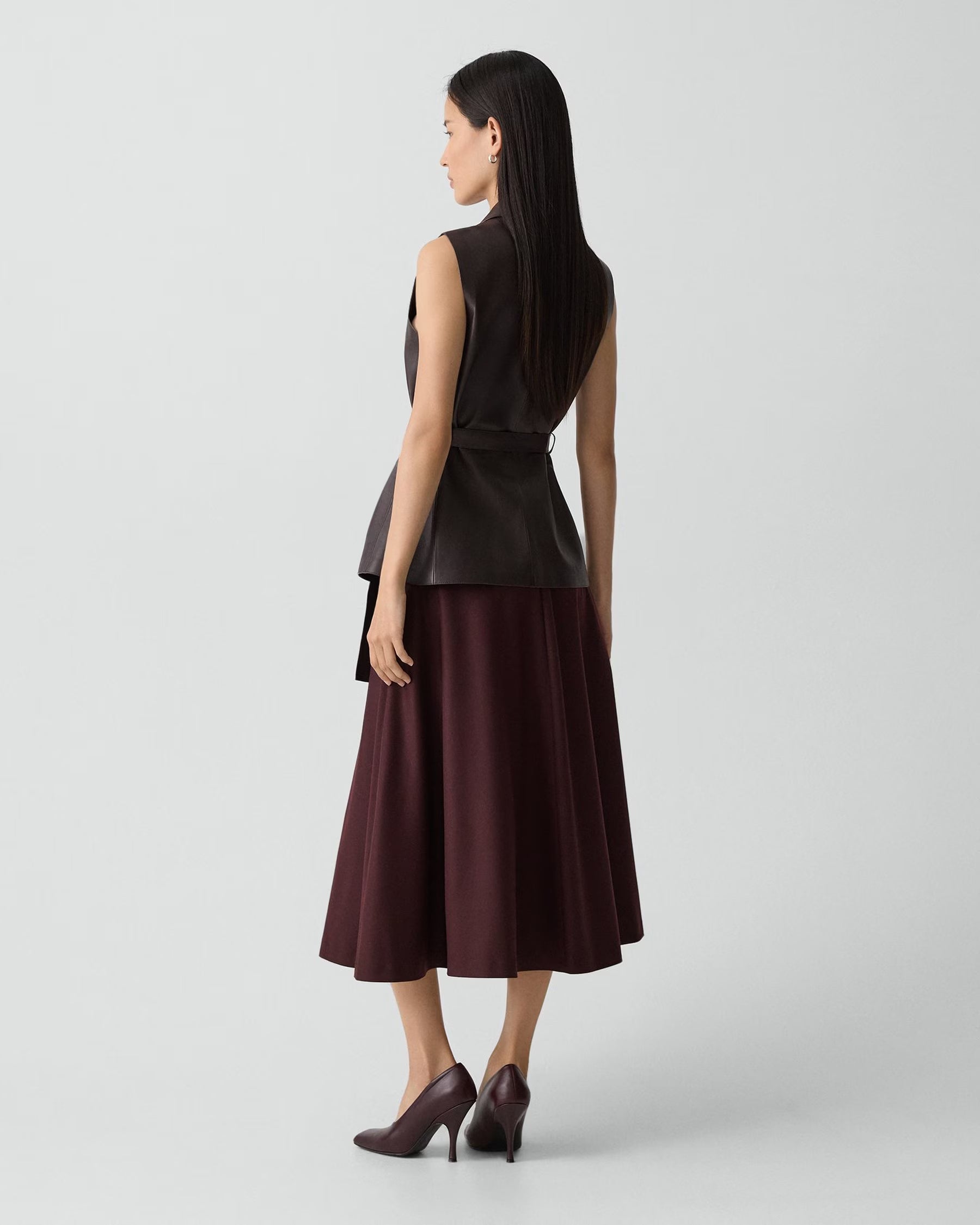 Woman wearing a two-tone dress with a white background
