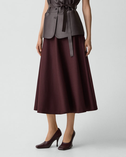 Woman wearing a brown dress with a belt on a white background