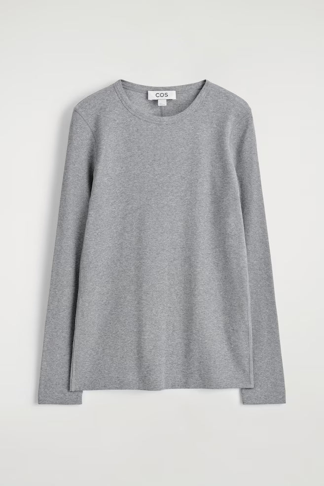 Gray long-sleeve shirt on a white background with 'COS' branding.