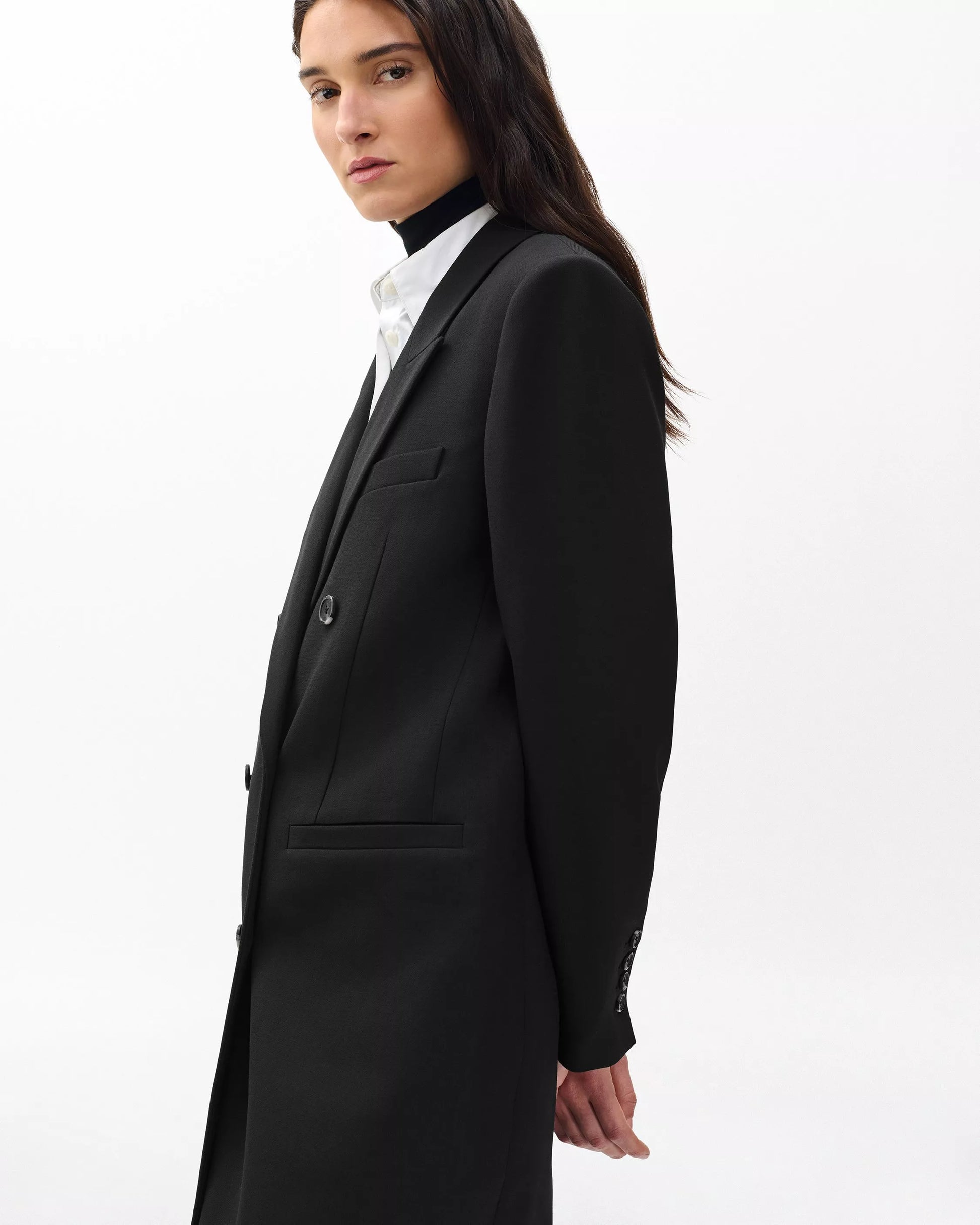 Person wearing a black coat on a white background