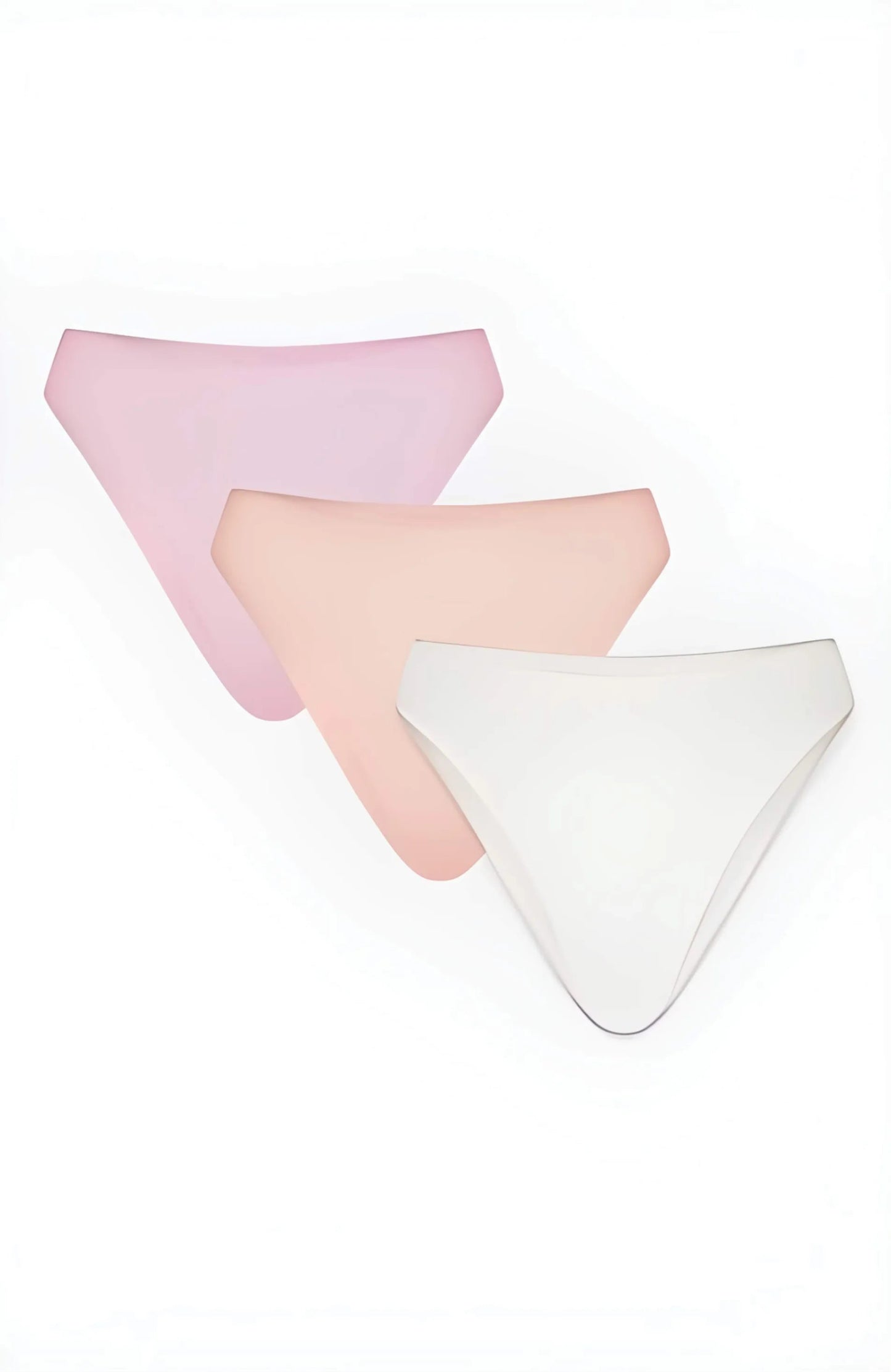 Three women's underwear pieces in pink, peach, and white on a white background