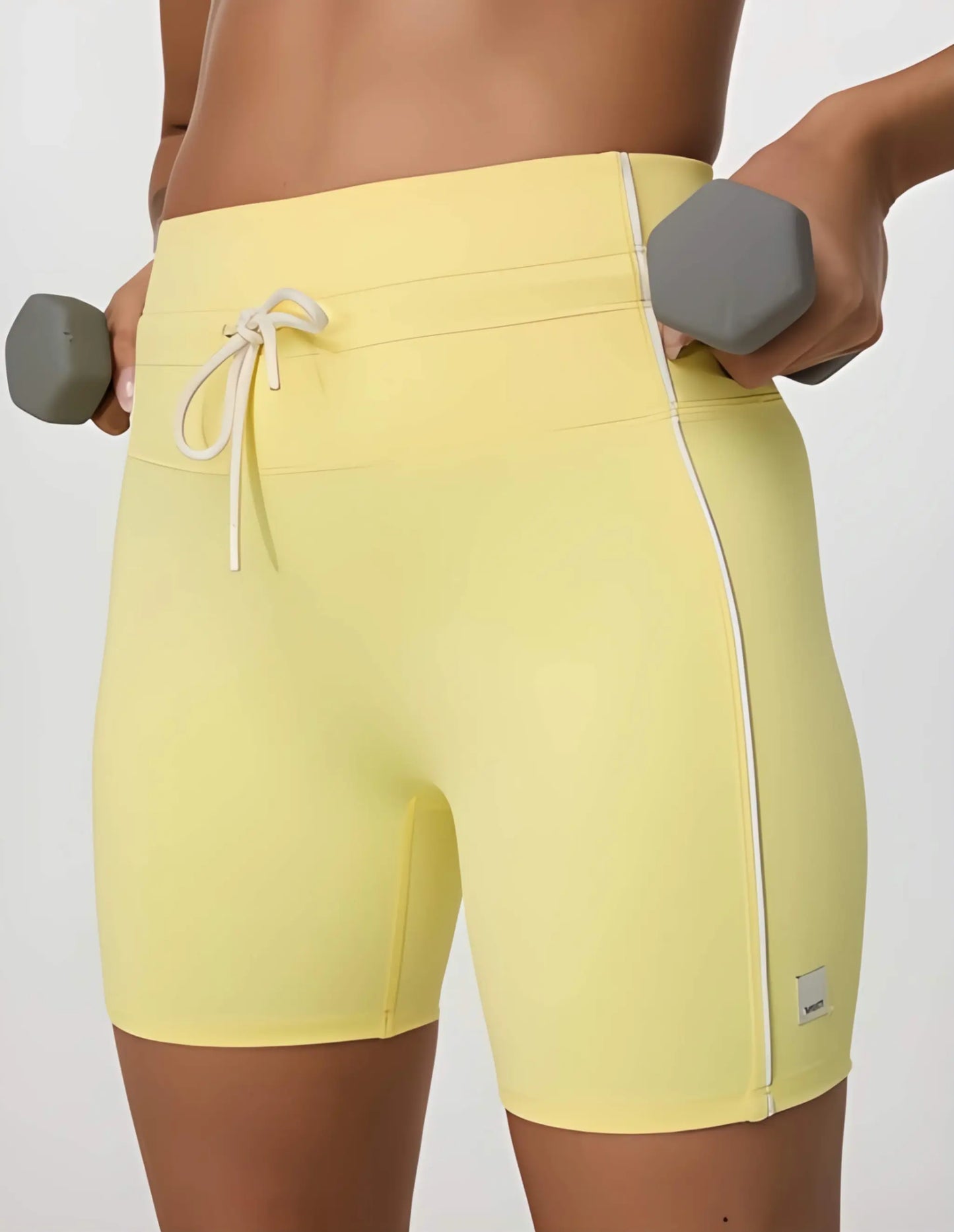 Daily Piped Short 5" in viridian green, showcasing the high-rise waistband and piped detailing on a model in a dynamic pose.