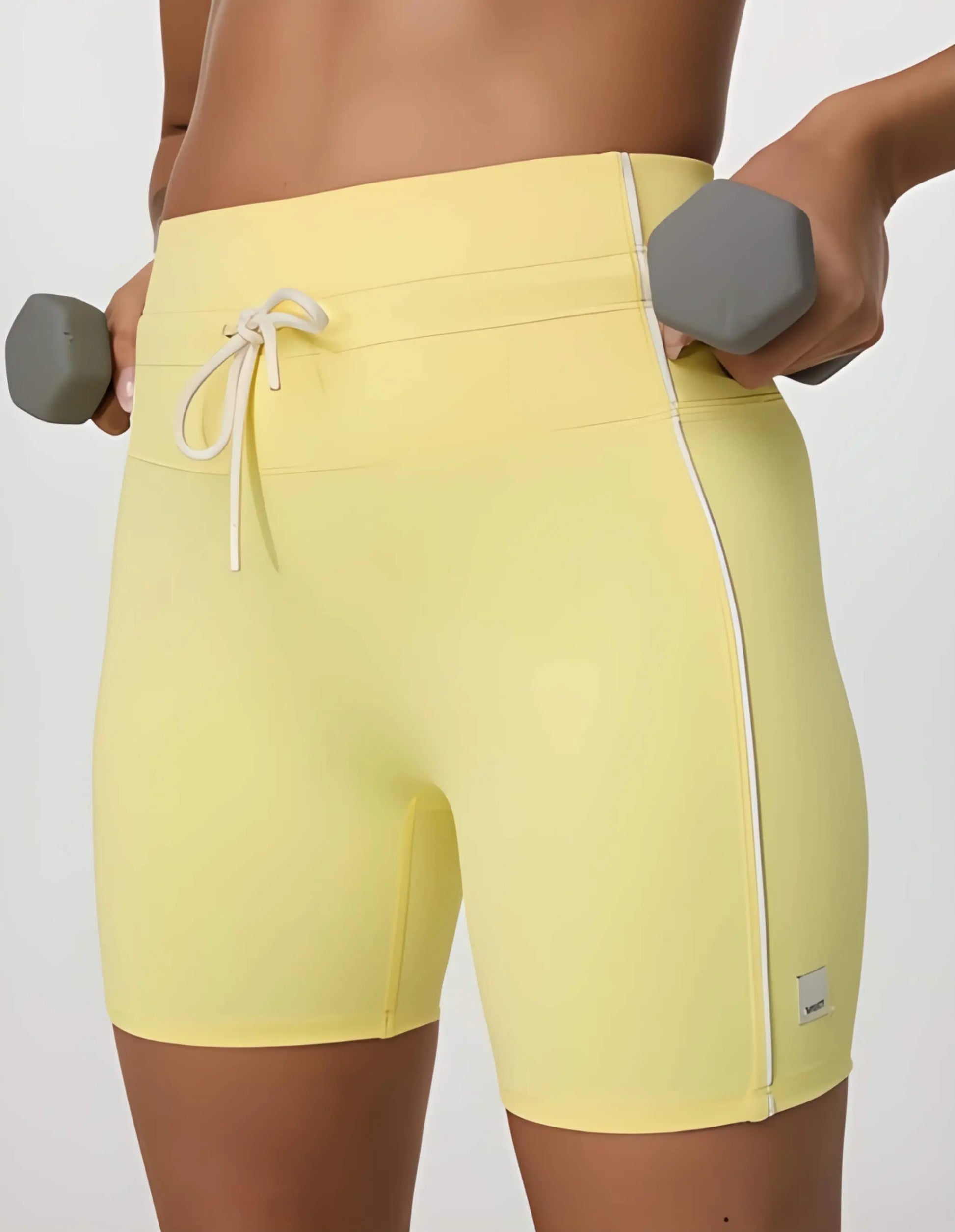 Daily Piped Short 5" in viridian green, showcasing the high-rise waistband and piped detailing on a model in a dynamic pose.