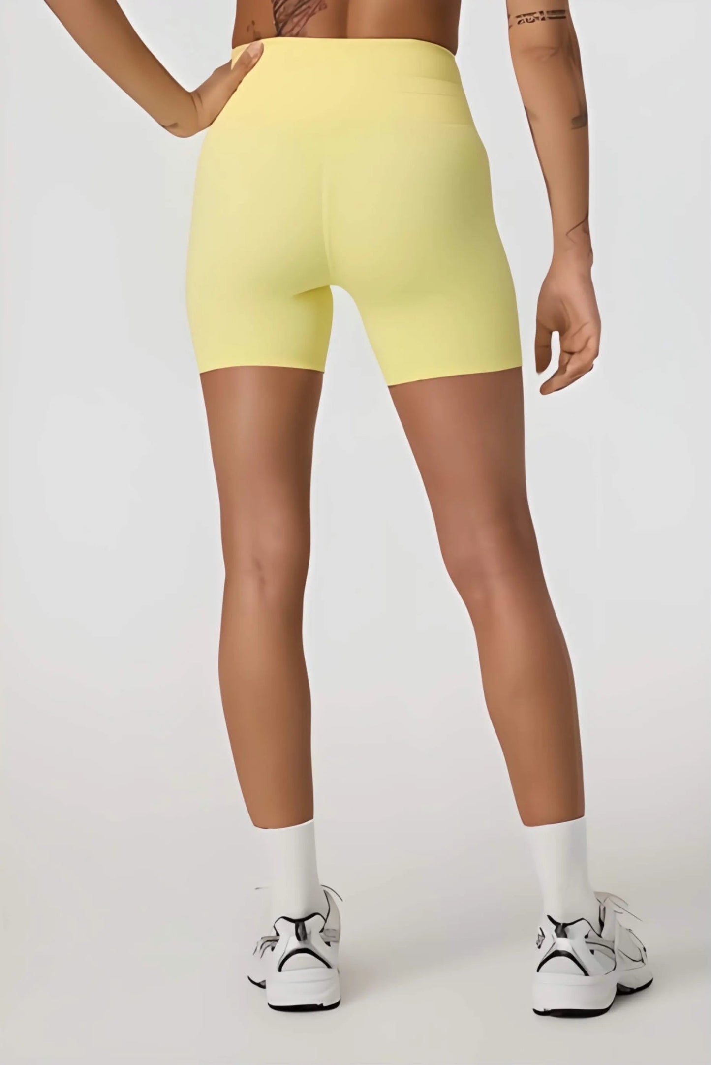 Daily Piped Short 5" in viridian green, showcasing the high-rise waistband and piped detailing on a model in a dynamic pose.
