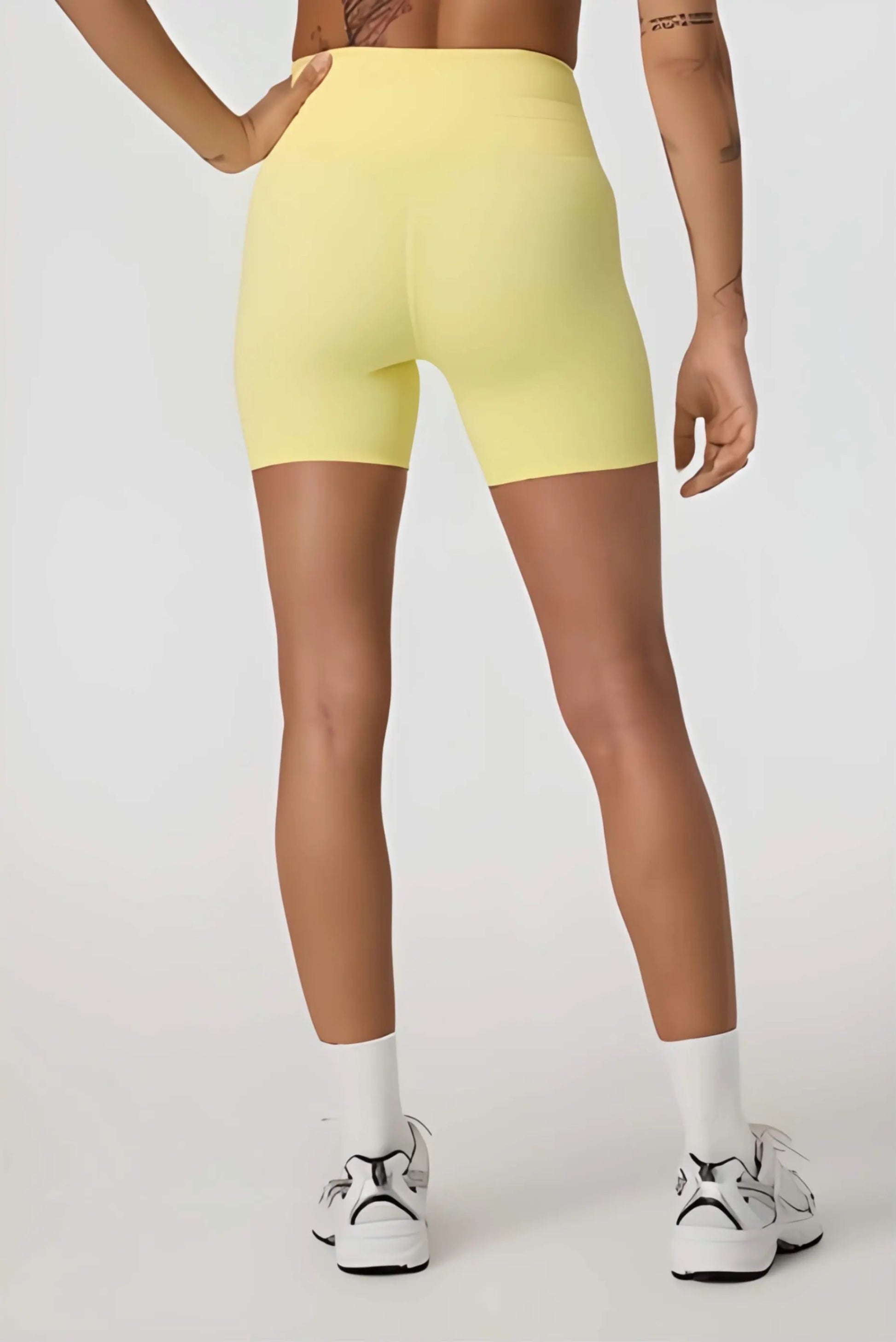 Daily Piped Short 5" in viridian green, showcasing the high-rise waistband and piped detailing on a model in a dynamic pose.