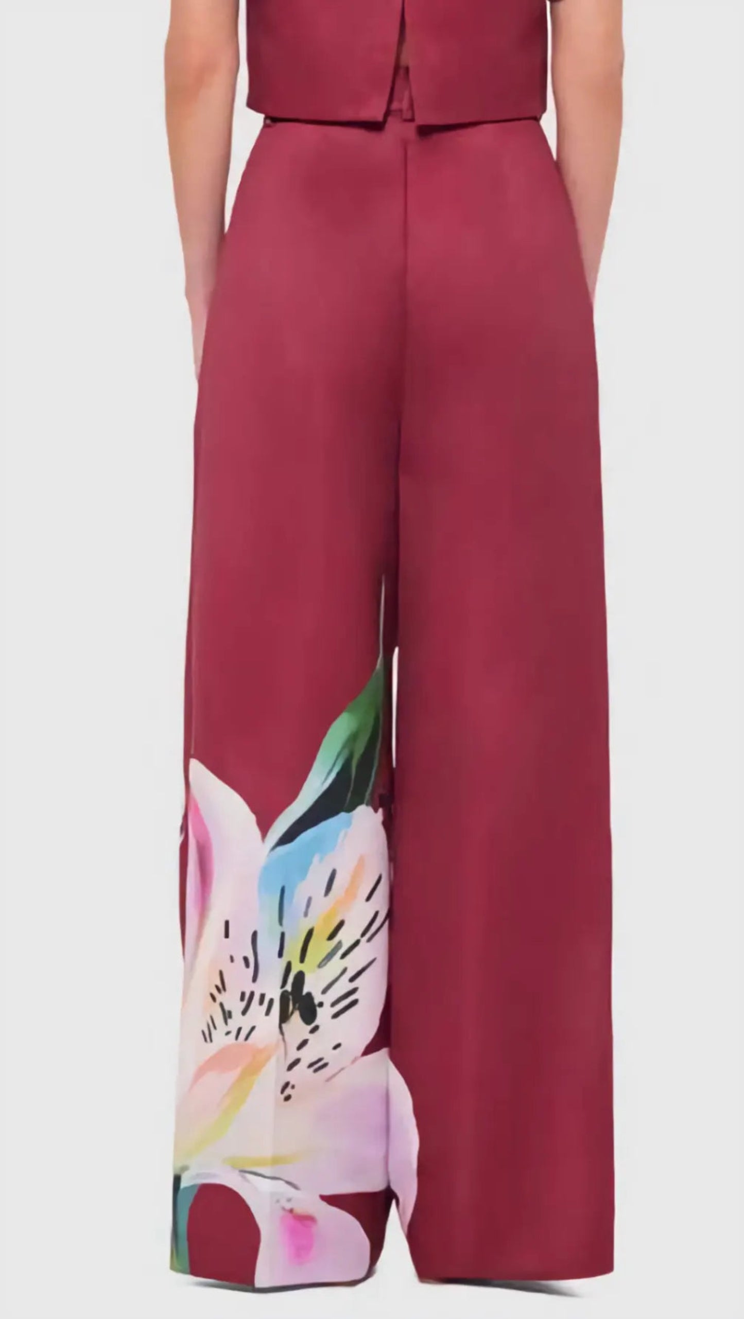 Red jumpsuit with floral design on a white background