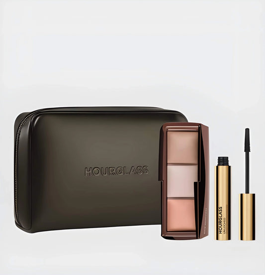 he Hourglass Essentials Set open on a marble surface, showcasing the Ambient Lighting Palette, Unlocked Mascara, and vegan leather bag for a ritual of radiant elegance.