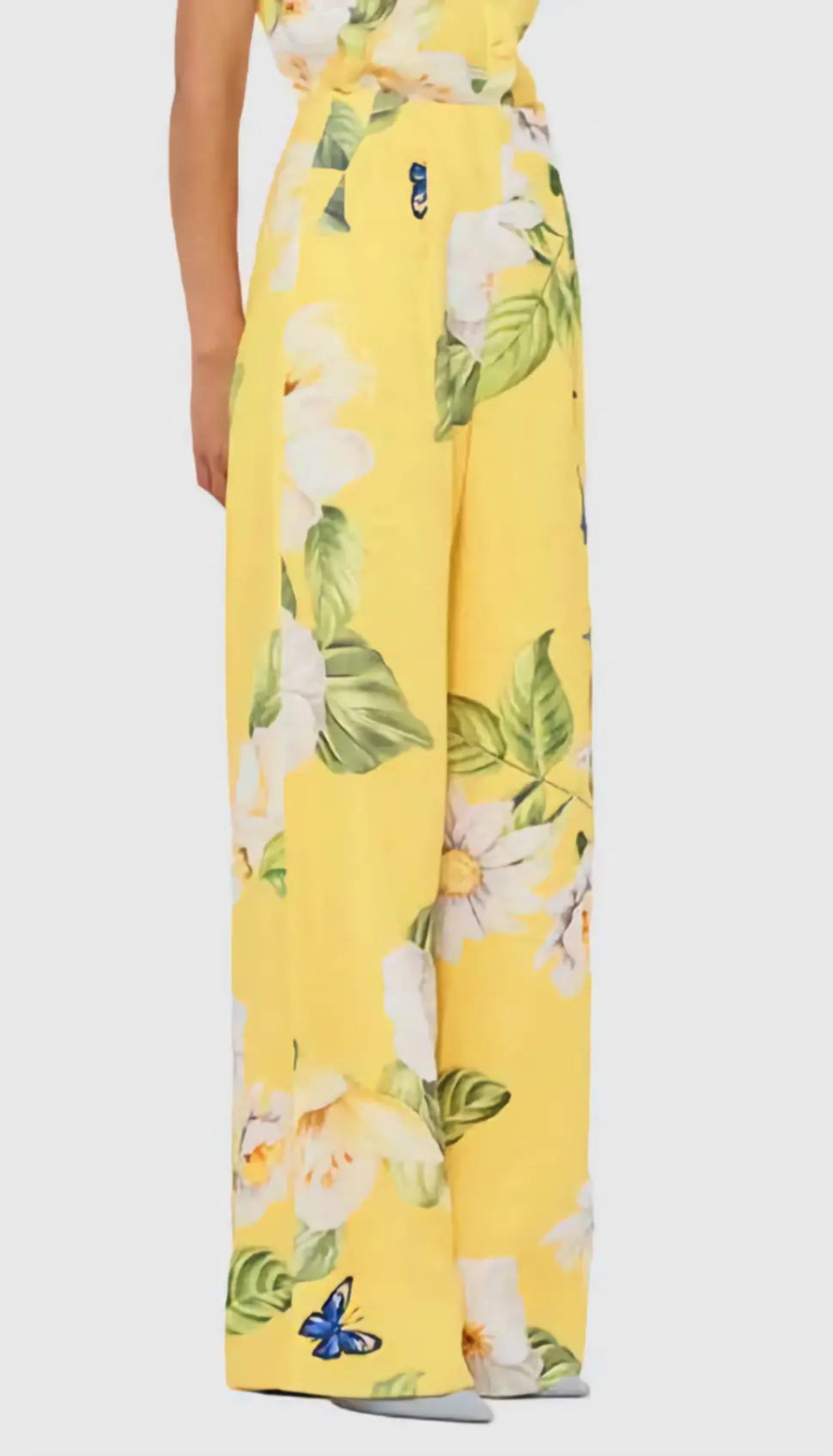 Yellow floral dress with white flowers and green leaves on a white background