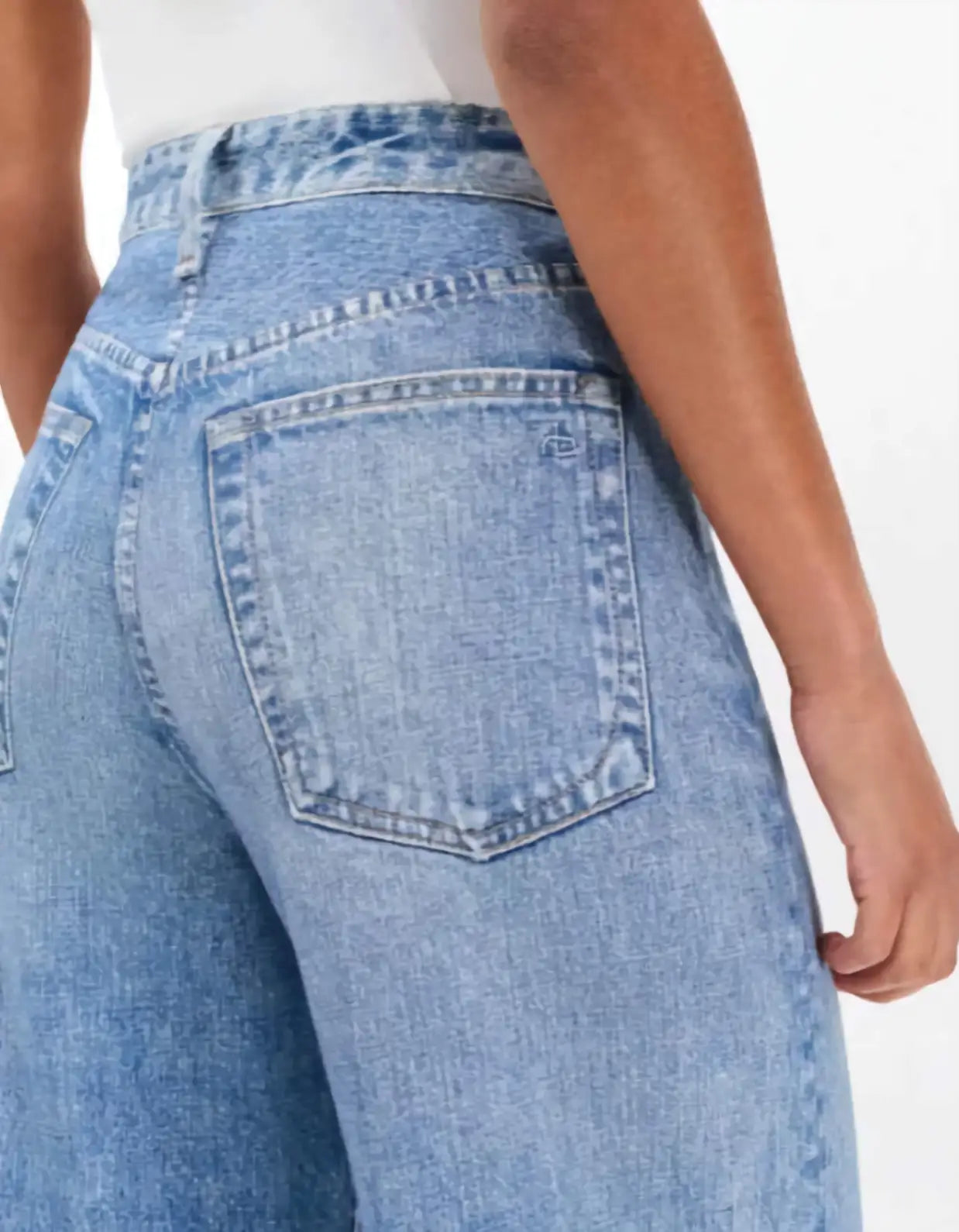 Close-up of blue jeans with a white background