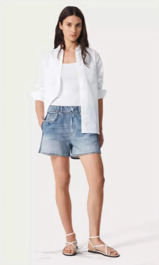 The Miramar Track Shorts in a digital denim illusion print, showcasing the cotton terry fabric and sporty side stripes on a model in an urban setting