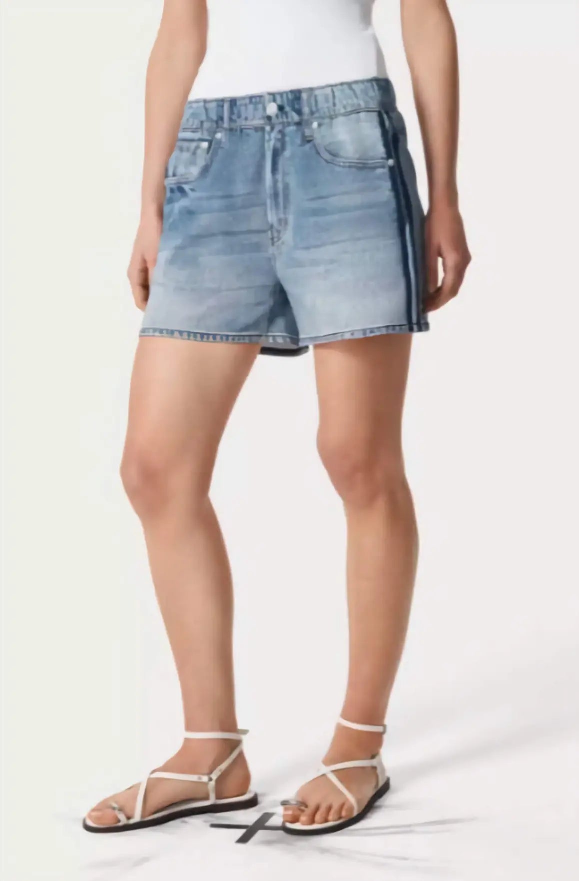Person wearing light blue denim shorts on a white background