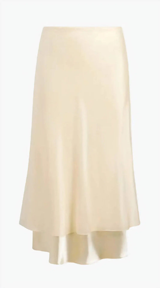 The Monina Skirt in black viscose satin, showcasing its fluid bias-cut drape on a model in motion, highlighting its matte-over-shine texture.