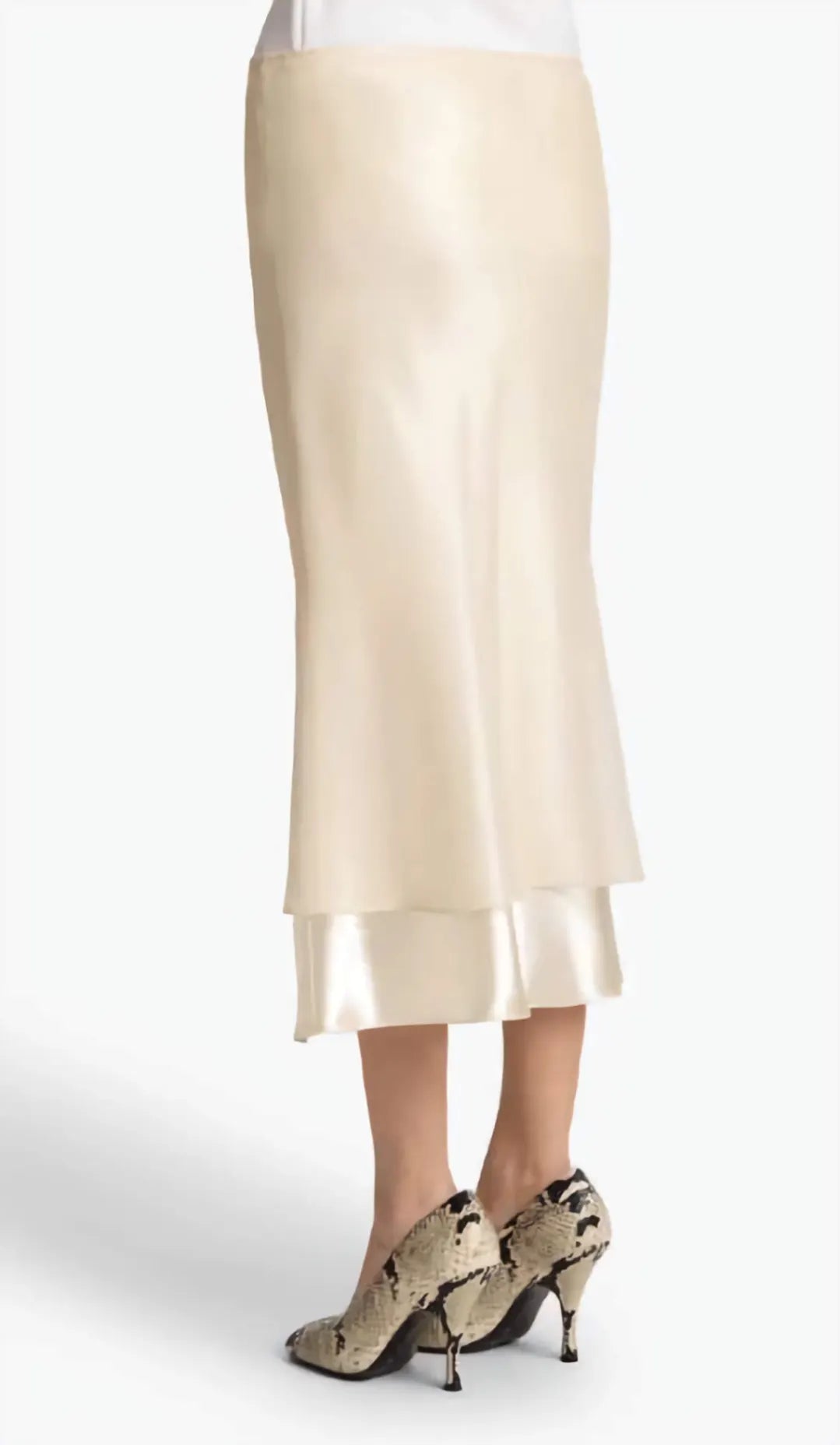 Beige skirt worn by a person on a white background