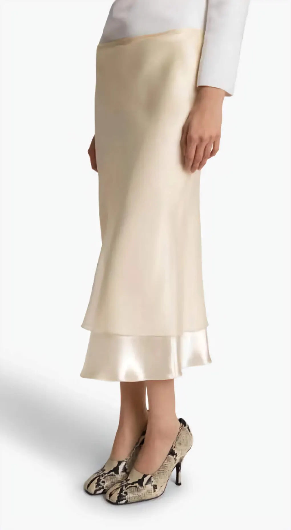 Beige satin skirt worn by a person on a white background