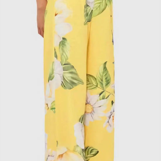 The Luisa Pants in vibrant canary yellow with hand-painted daisy and camellia print, showcasing the wide-leg silhouette and high banded waist.