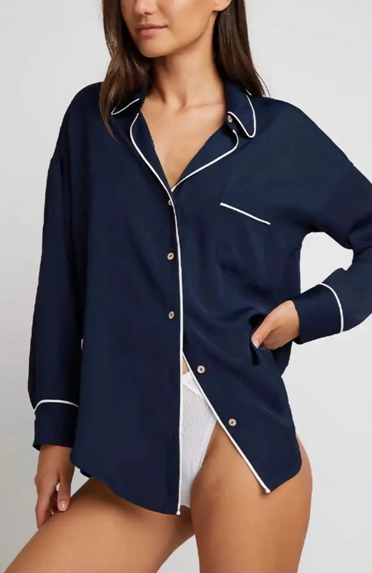 The Supreme Shirt in deep navy with crisp white contrast piping, shown on a model, highlighting the relaxed boyfriend cut and sophisticated drape