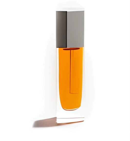 The Beautiful Oil in its iconic Kjaer Weis packaging, with a drop of the golden elixir on skin, showcasing its dewy, non-greasy finish