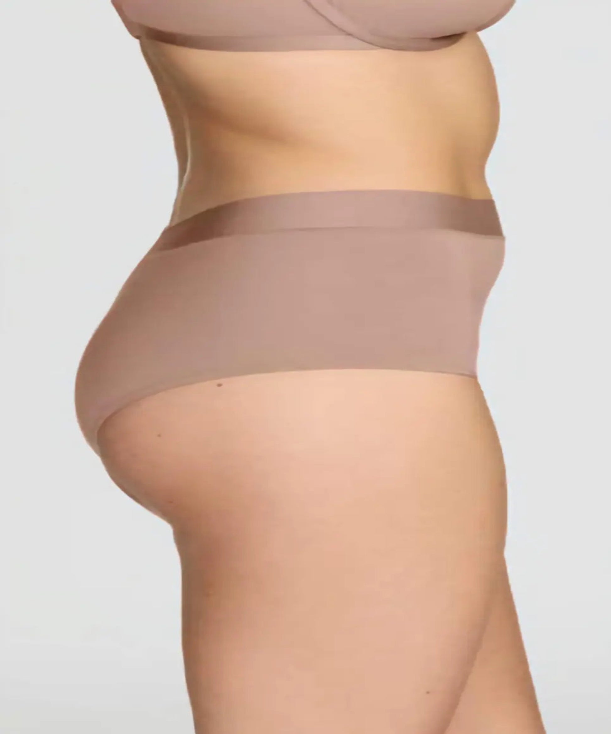 Beige shapewear worn by a person on a plain background