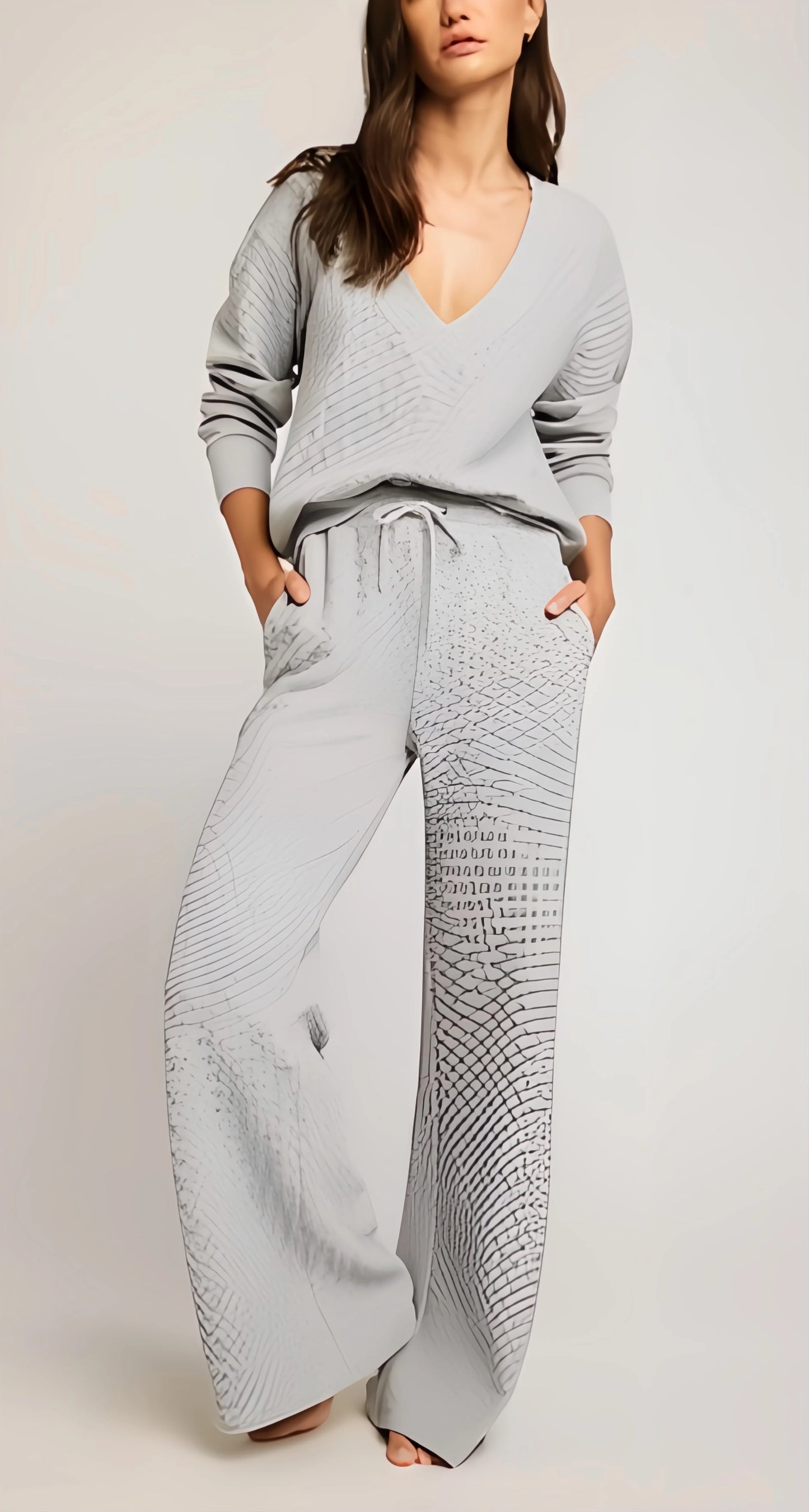 Woman wearing a light gray lounge set on a plain background