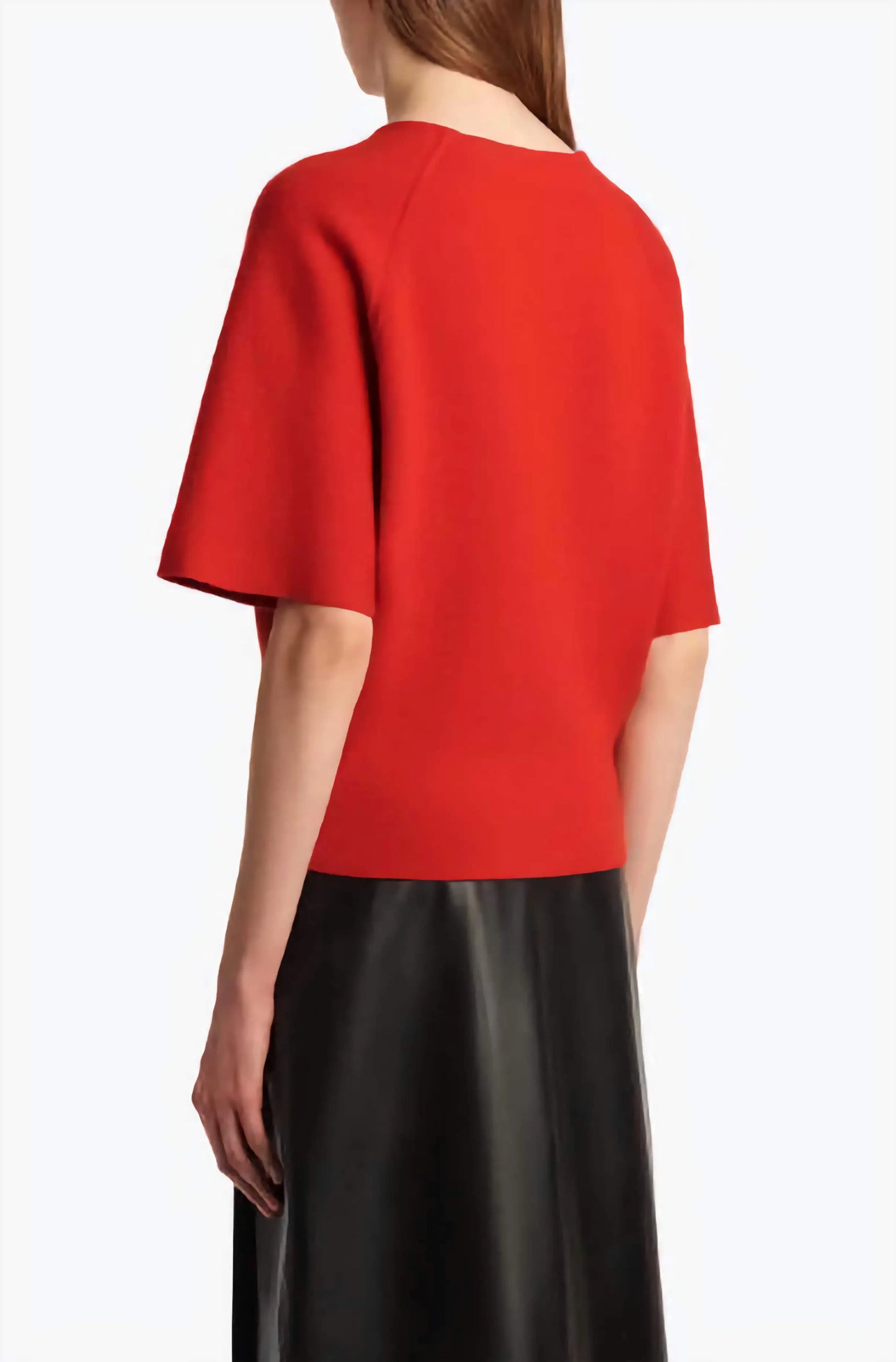Red top worn by a person on a white background