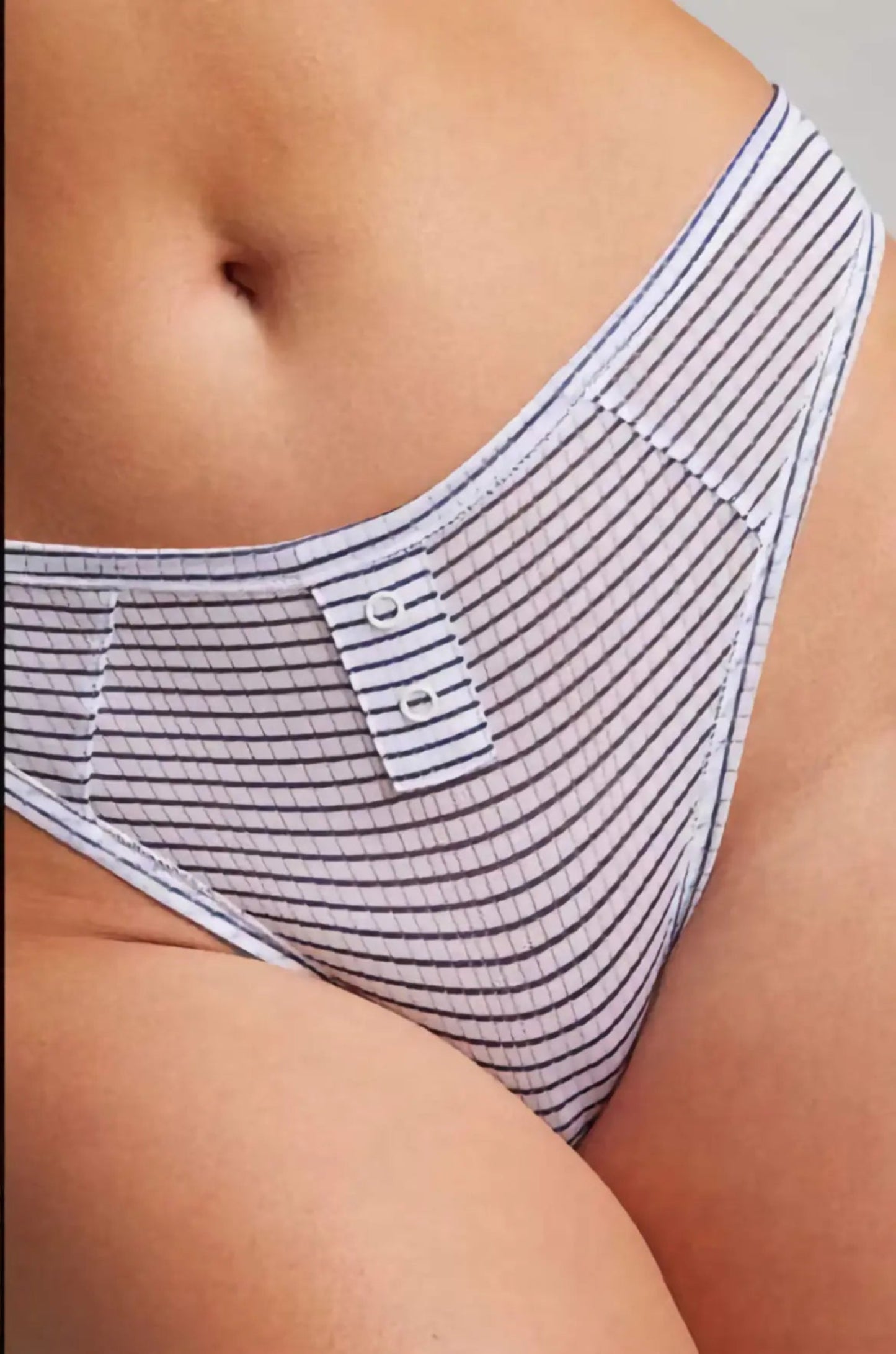 Striped underwear with a brand label on a neutral background