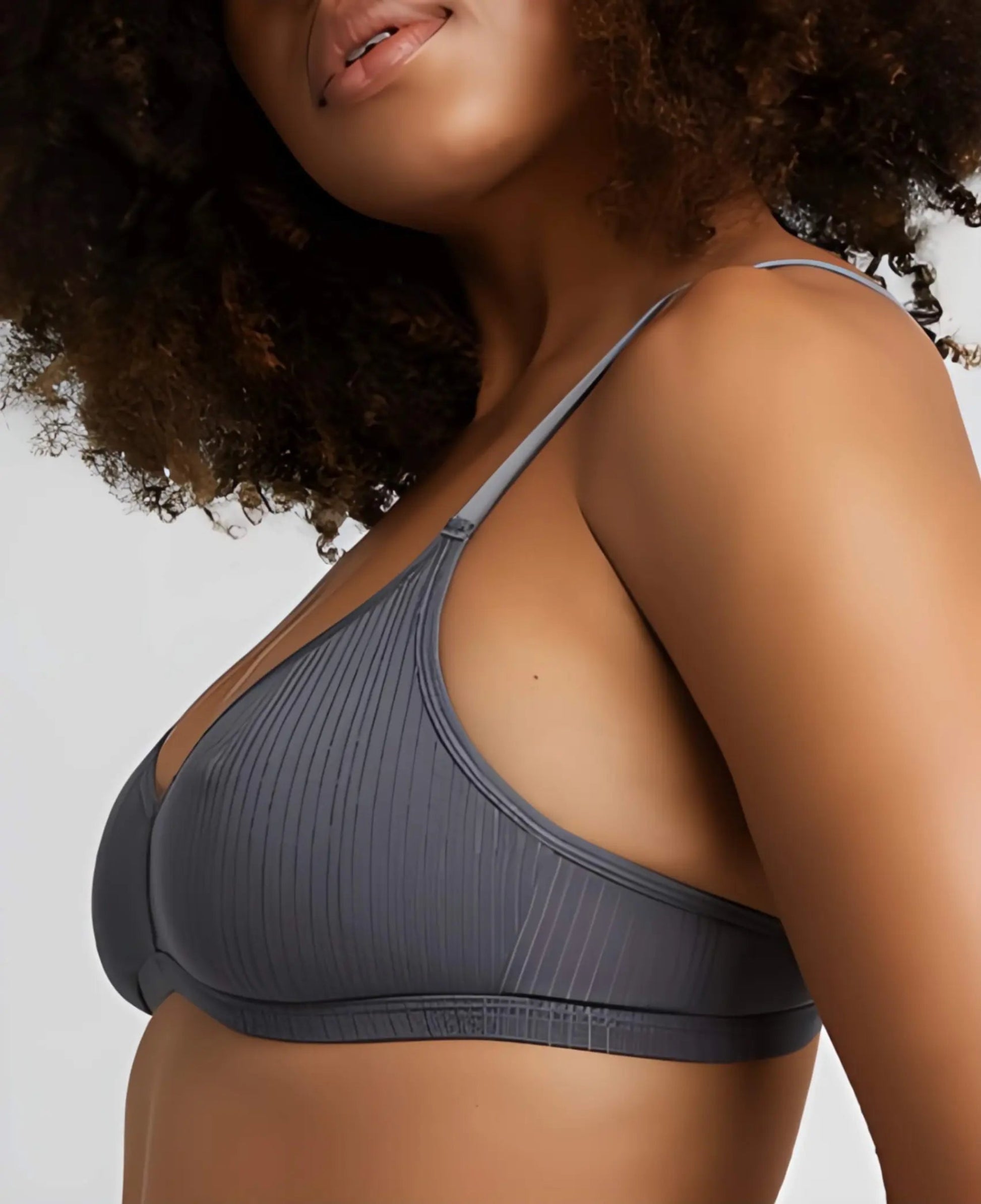 Gray bra worn by a model on a plain background